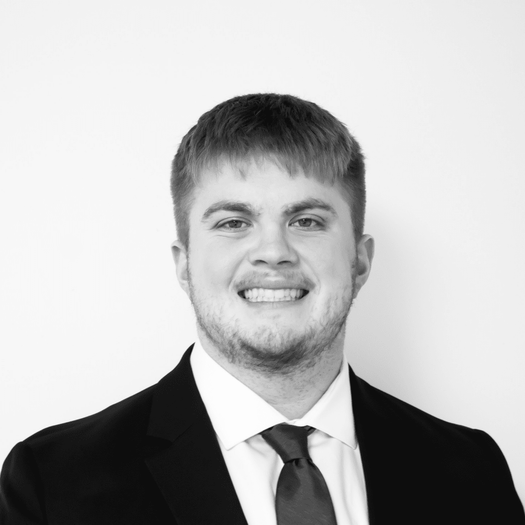 Smiling man in suit and tie.