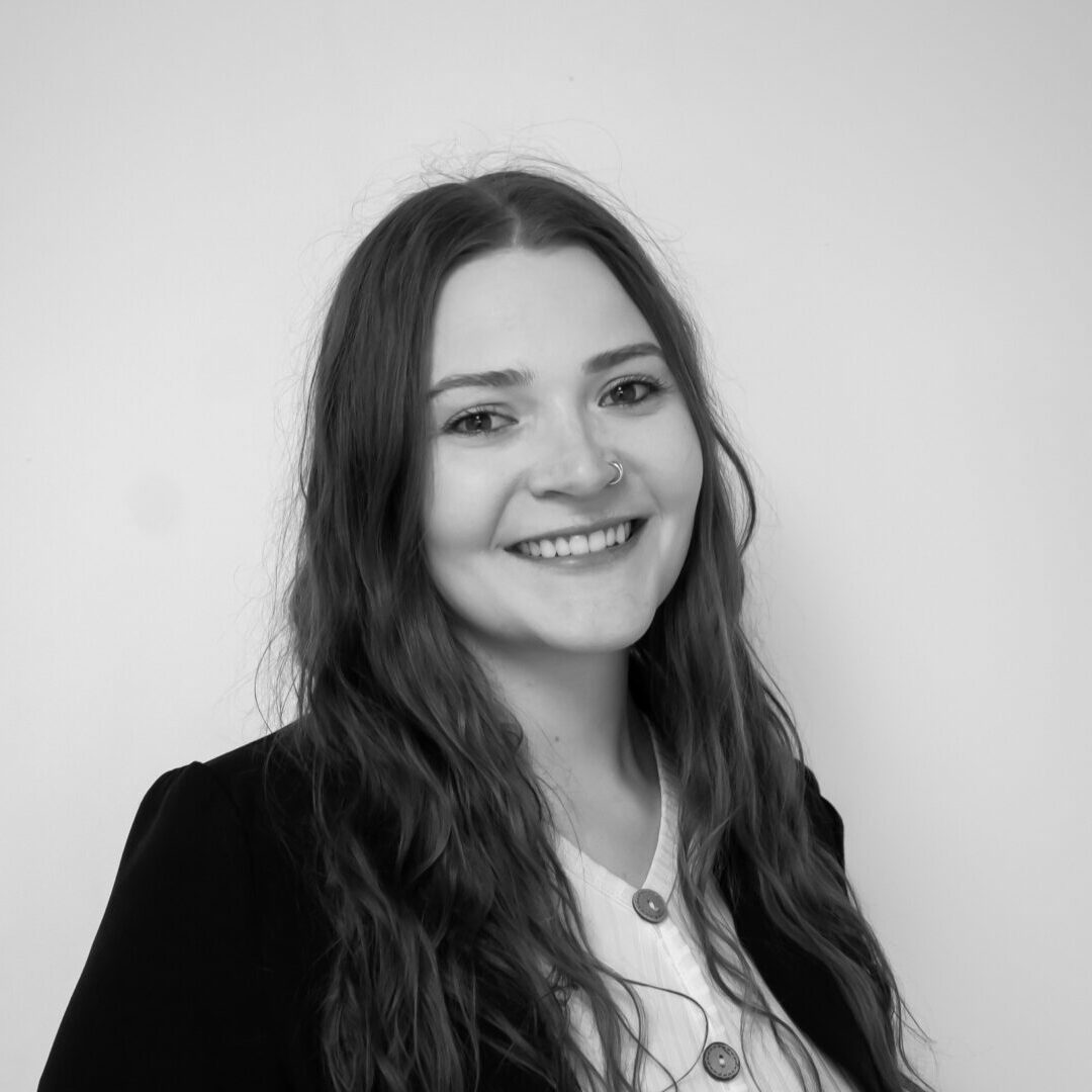 Smiling woman in black and white portrait.