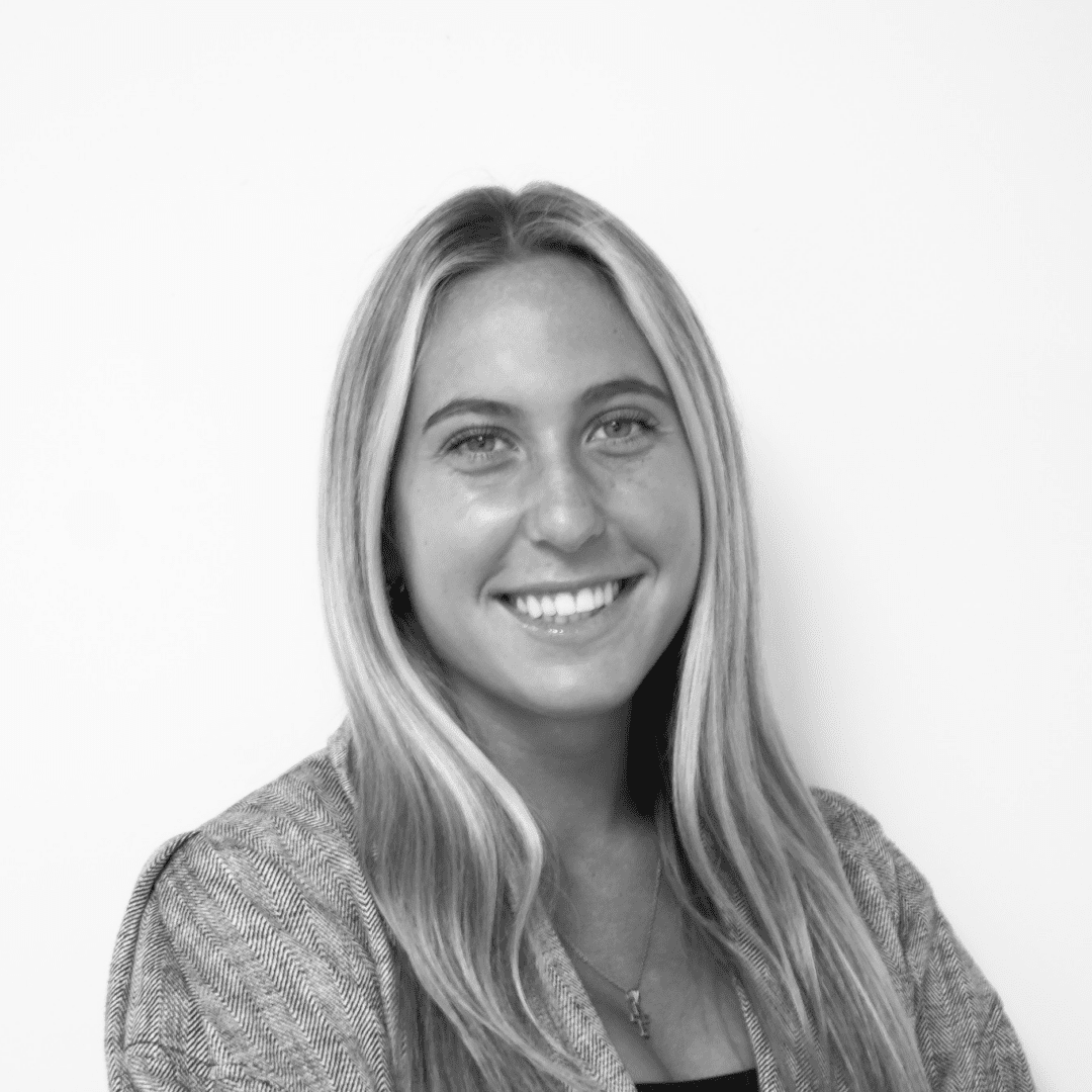 Smiling woman with long hair, black and white.